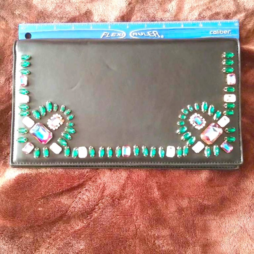 Bebe black leather jeweled clutch. Few indent marks but in like new condition.